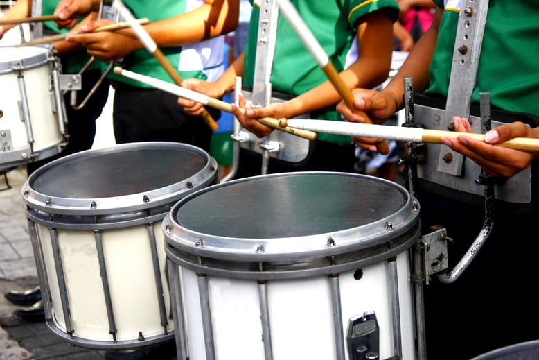 Marching band's drummers playing the drums